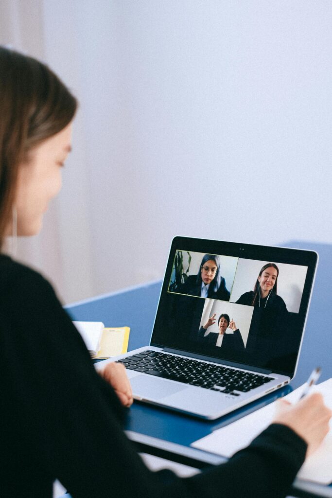 pexels photo 4226122 4226122 A woman participates in a virtual meeting with colleagues via video call on a laptop.